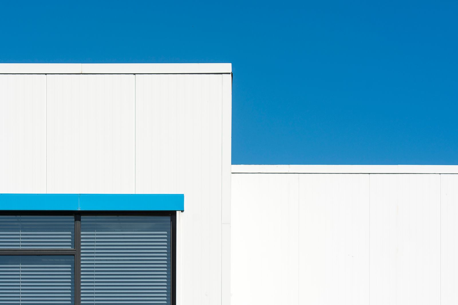 White TPO membrane roof with heat-welded seams on a warehouse